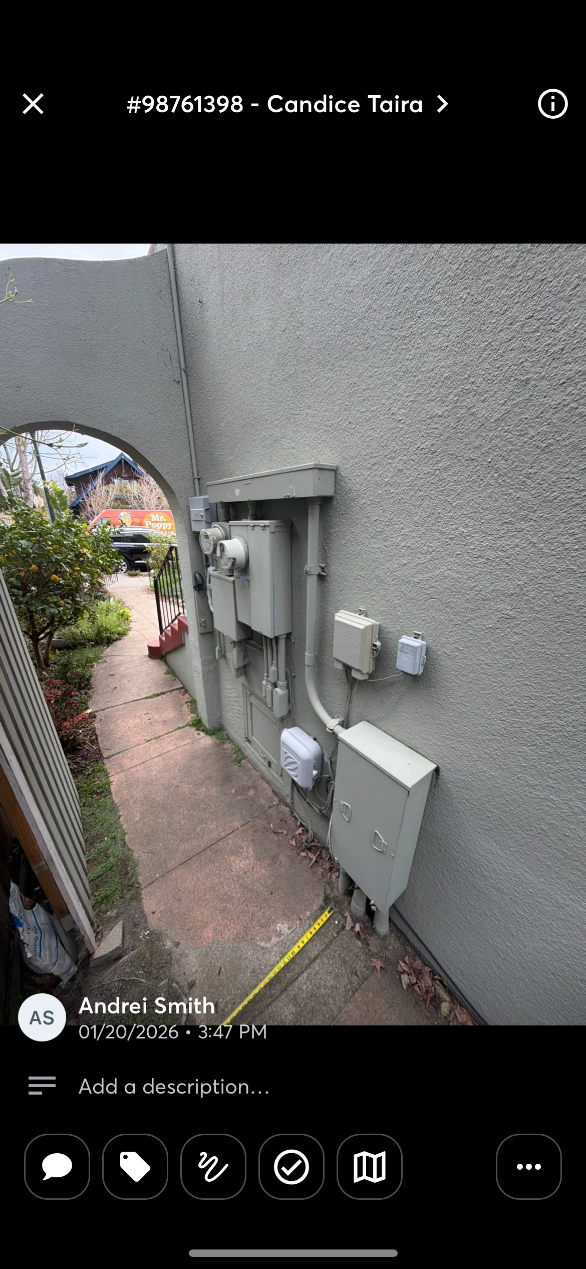 Electrical panel with breakers and white outlet boxes mounted on textured exterior wall
